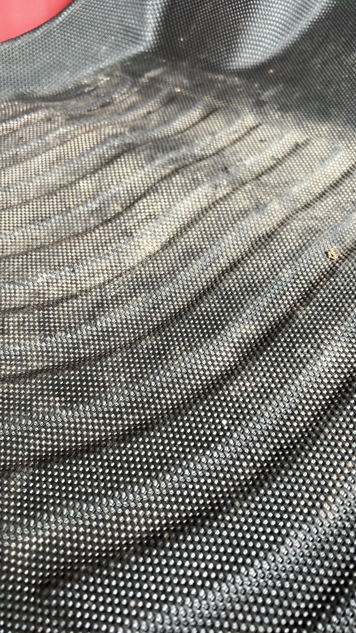 Dirt and residue caught in the textured surface of a comparison mat